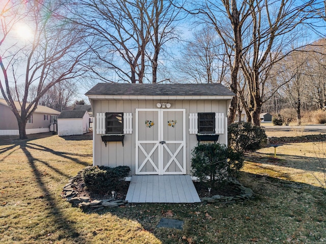 view of outbuilding with a yard