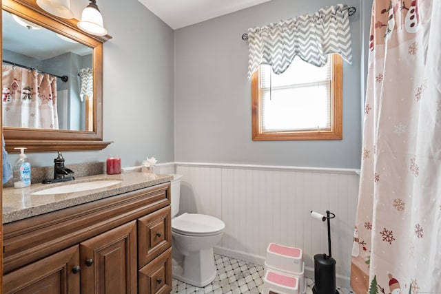 bathroom featuring toilet, tile patterned floors, and vanity