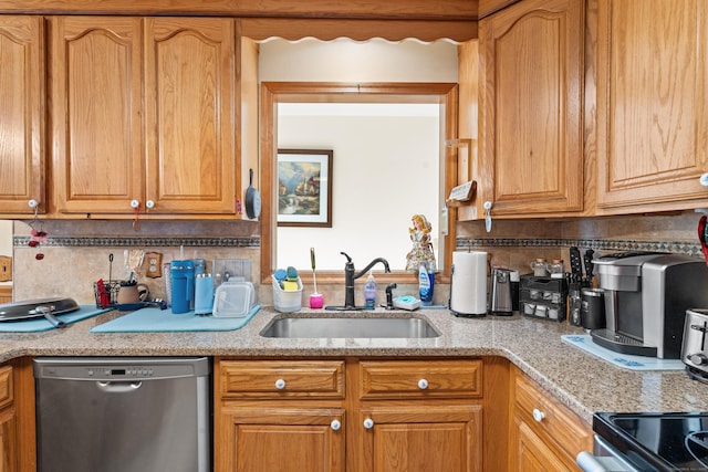 kitchen with light stone countertops, dishwasher, tasteful backsplash, and sink