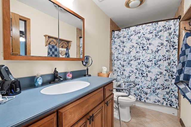 bathroom with toilet, vanity, and tile patterned floors