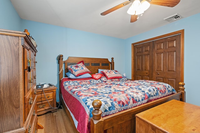 bedroom featuring ceiling fan, a closet, and light hardwood / wood-style flooring