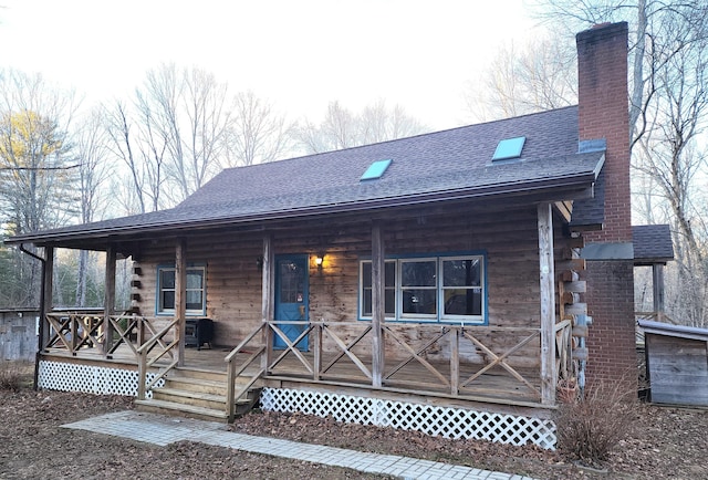 rear view of house featuring covered porch