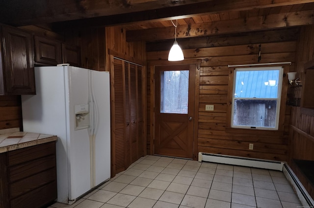 kitchen with white fridge with ice dispenser, wood ceiling, hanging light fixtures, wood walls, and beam ceiling