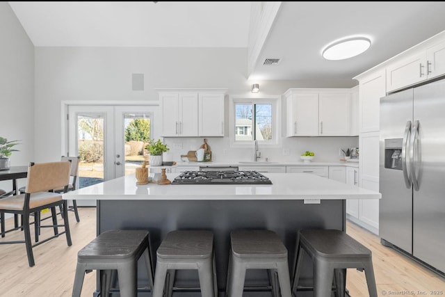 kitchen featuring white cabinetry, stainless steel appliances, and french doors