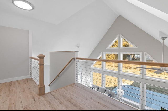 interior space with a healthy amount of sunlight, vaulted ceiling, and light hardwood / wood-style floors