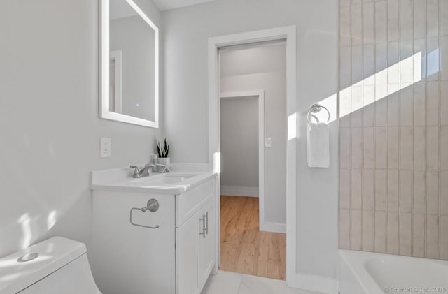 bathroom featuring toilet and vanity