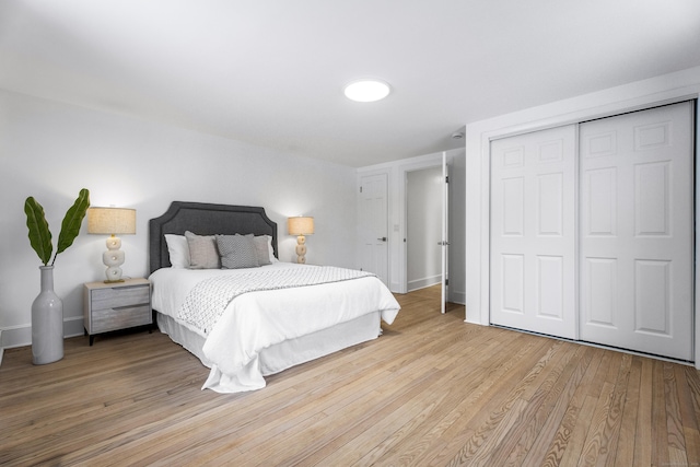 bedroom featuring a closet and light wood-type flooring