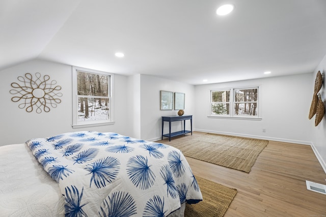 bedroom with lofted ceiling and hardwood / wood-style flooring