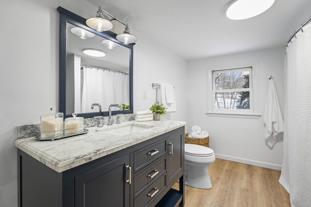 bathroom featuring vanity, hardwood / wood-style floors, and toilet