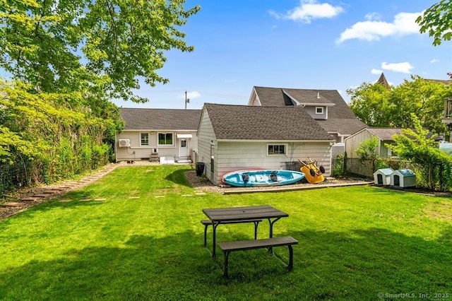 rear view of property featuring a yard