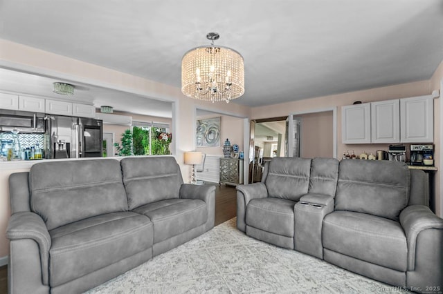 living room featuring wood-type flooring and a notable chandelier