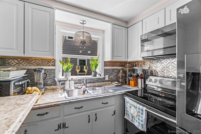 kitchen with decorative backsplash, sink, white cabinetry, and stainless steel appliances