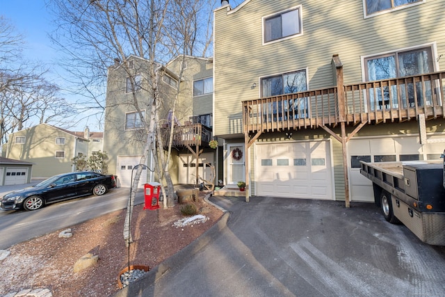 townhome / multi-family property with a balcony and a garage