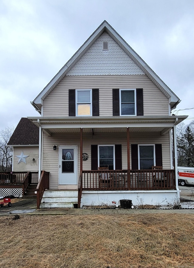 view of front of property with a front yard and a porch