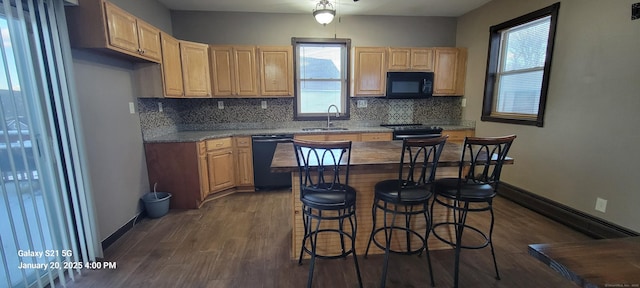 kitchen with black appliances, dark hardwood / wood-style flooring, sink, and tasteful backsplash