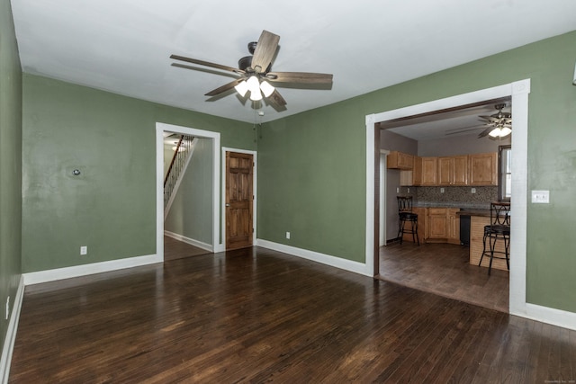 unfurnished room with ceiling fan and dark hardwood / wood-style flooring