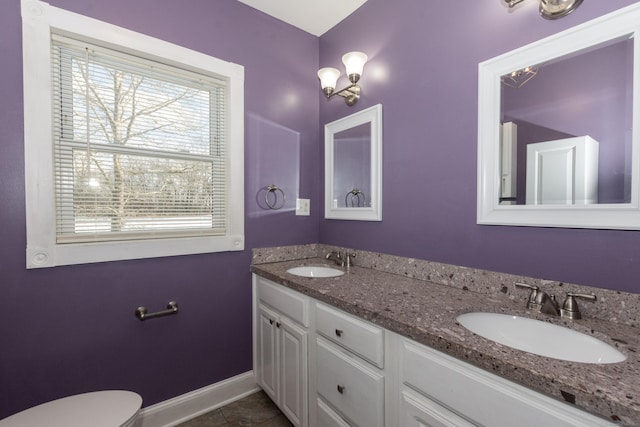 bathroom featuring toilet, tile patterned floors, and vanity