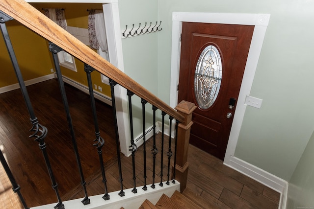 foyer with a baseboard heating unit and dark hardwood / wood-style flooring