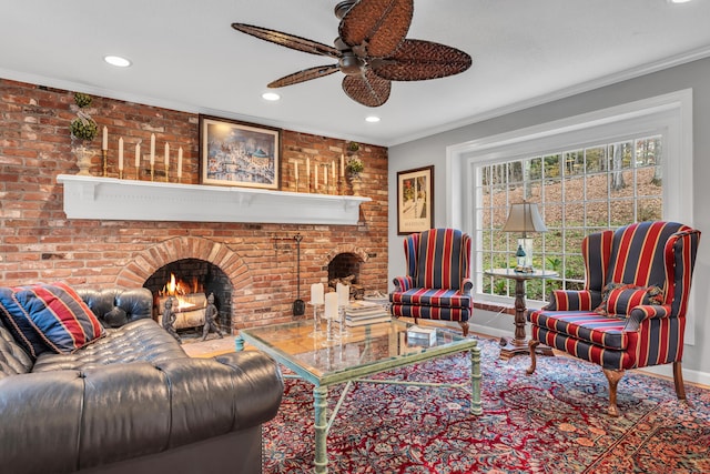 living room with ceiling fan, brick wall, ornamental molding, and a fireplace