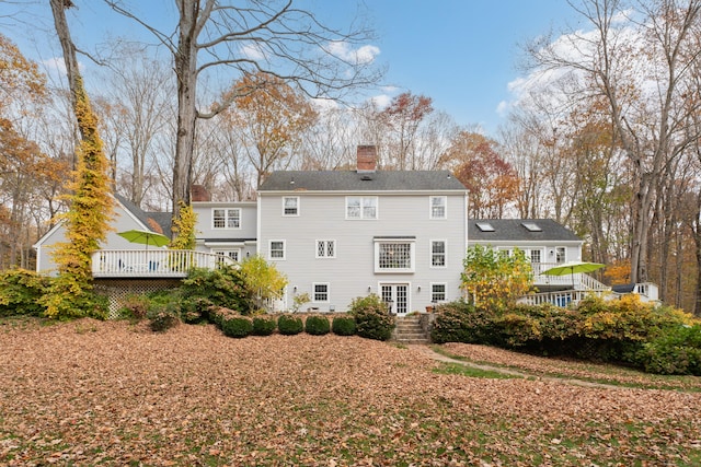 rear view of property featuring a wooden deck