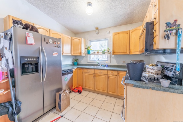 kitchen featuring light tile patterned flooring, appliances with stainless steel finishes, sink, light brown cabinets, and a textured ceiling