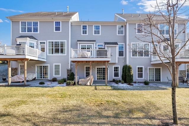 rear view of house featuring a patio and a lawn