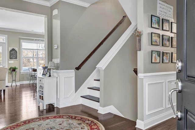 entrance foyer with stairs, ornamental molding, dark wood-style flooring, and baseboards