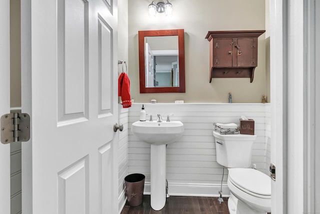 bathroom featuring a sink, wood finished floors, and toilet