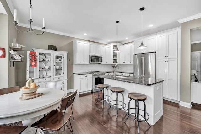 kitchen with white cabinets, glass insert cabinets, stainless steel appliances, and a sink