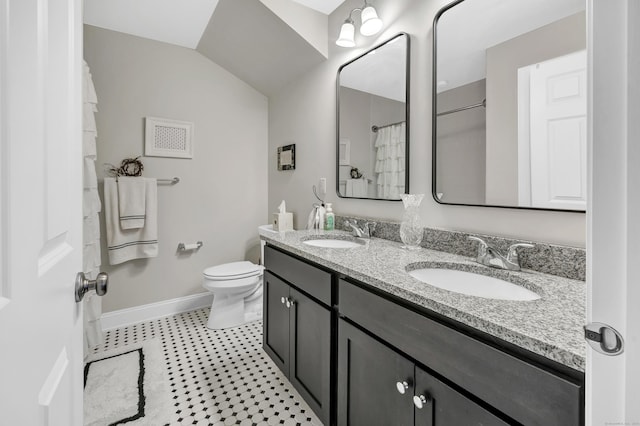 full bath with vaulted ceiling, double vanity, a sink, and baseboards