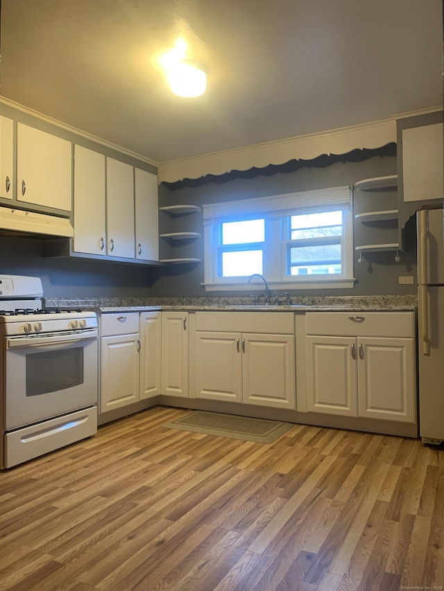 kitchen featuring sink, white cabinets, light hardwood / wood-style flooring, and white appliances