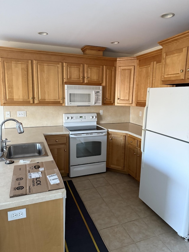 kitchen with light tile patterned floors, sink, and white appliances