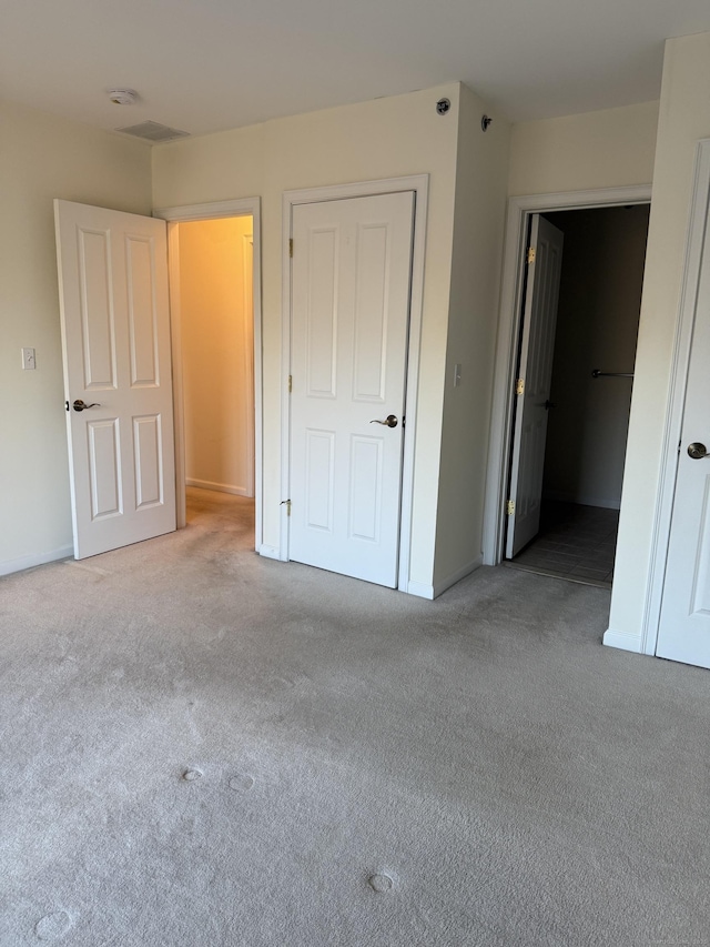 unfurnished bedroom featuring a closet and carpet floors