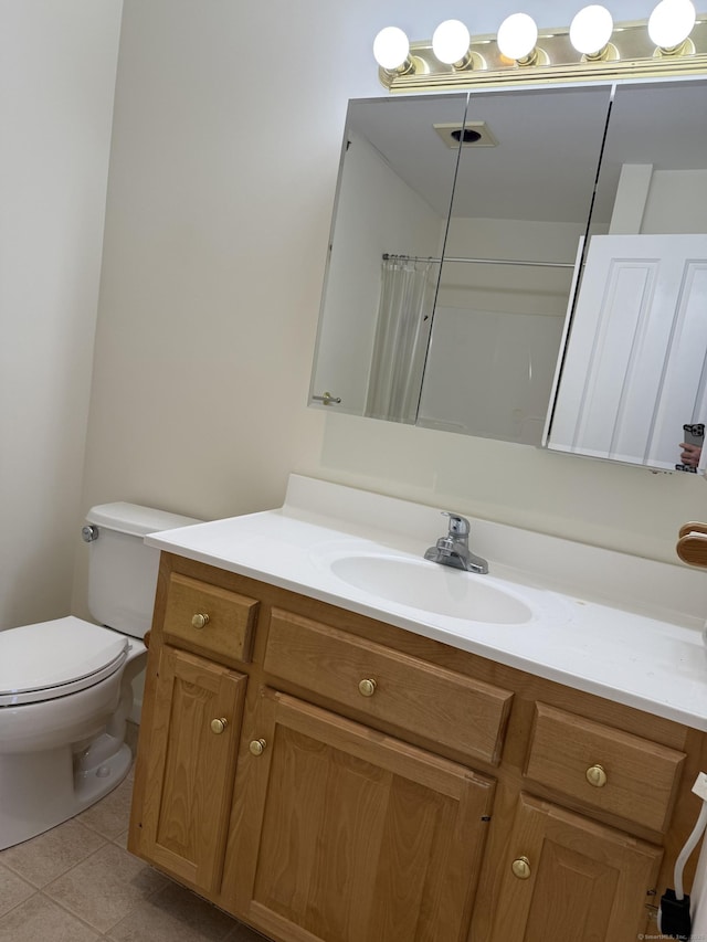 bathroom with tile patterned floors, toilet, vanity, and a shower with curtain