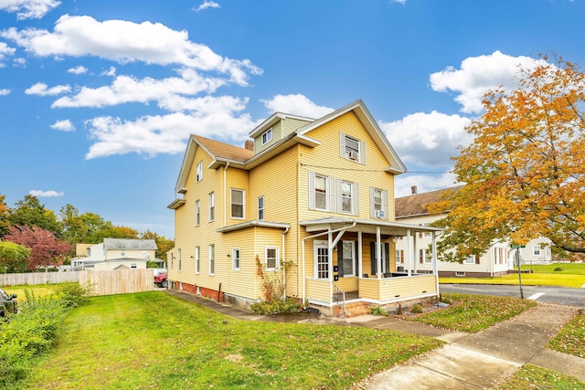 view of front of property with covered porch and a front lawn