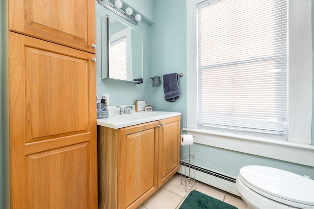 bathroom with baseboard heating, toilet, vanity, and tile patterned flooring