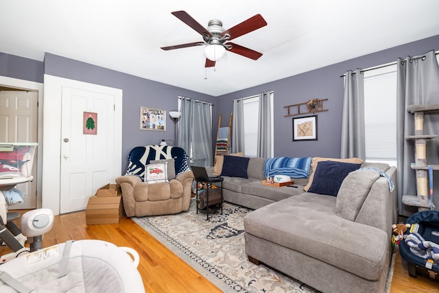 living room with hardwood / wood-style flooring and ceiling fan