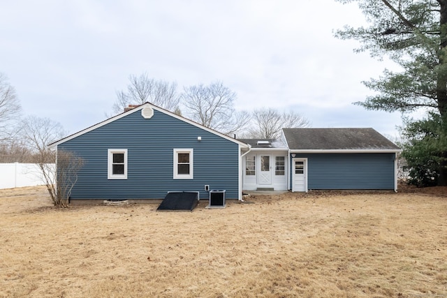 back of house featuring cooling unit and a yard