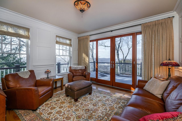 interior space with ornamental molding, a wealth of natural light, and french doors