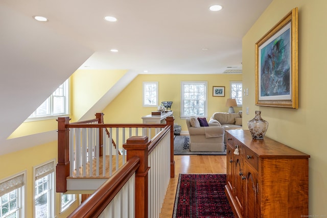 hallway featuring plenty of natural light and light hardwood / wood-style flooring