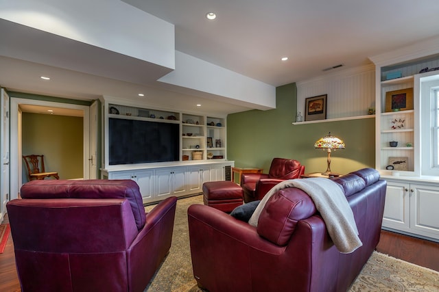 living room featuring built in shelves and dark wood-type flooring