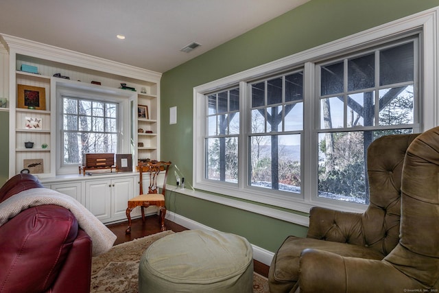 living area with hardwood / wood-style flooring and built in features