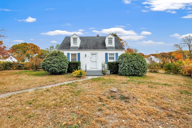 cape cod house with a front lawn