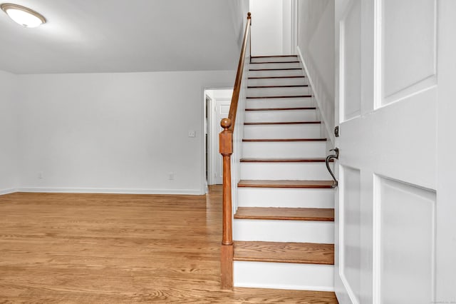 staircase with hardwood / wood-style flooring