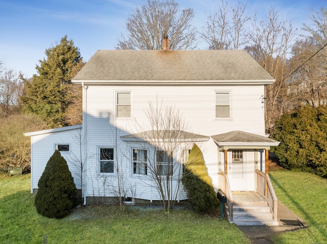 back of property with a lawn