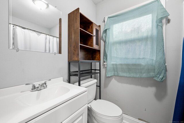 bathroom featuring vanity and toilet