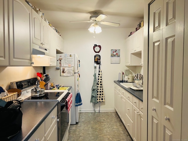 kitchen featuring ceiling fan, range with electric stovetop, and white cabinets