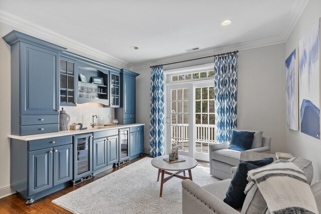 living room featuring indoor wet bar, wine cooler, dark hardwood / wood-style floors, and ornamental molding