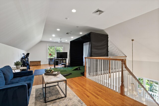 living room featuring ceiling fan, wood-type flooring, and lofted ceiling