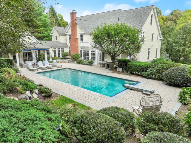 view of swimming pool with a patio area, a jacuzzi, and french doors